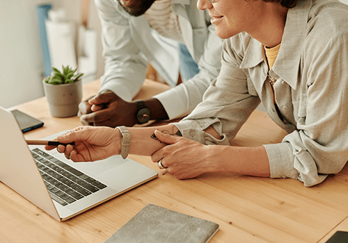 Marketing team reviewing email records on laptop – Email appending process for updating customer contact databases