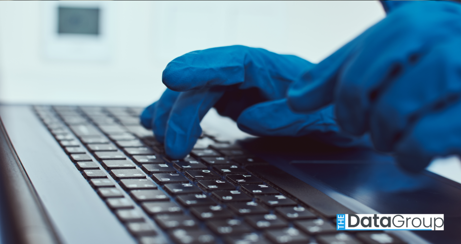 An extreme close up shot shows gloved hands typing on a laptop keyboard. The blue gloves contrast with the black keyboard, highlighting the attention to cleanliness or safety. The shot is brightly lit, suggesting a sterile environment or workplace. The composition centers on the hands and keyboard, perfect for projects about technology, workplace safety, hygiene, or digital security. Useful for conveying themes of careful attention to detail and precision when using computers.