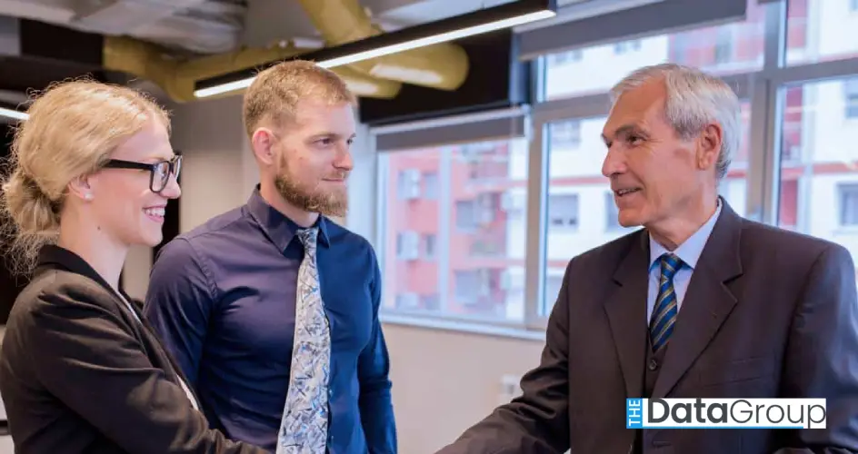 happy business people shaking hands after finishing up meeting